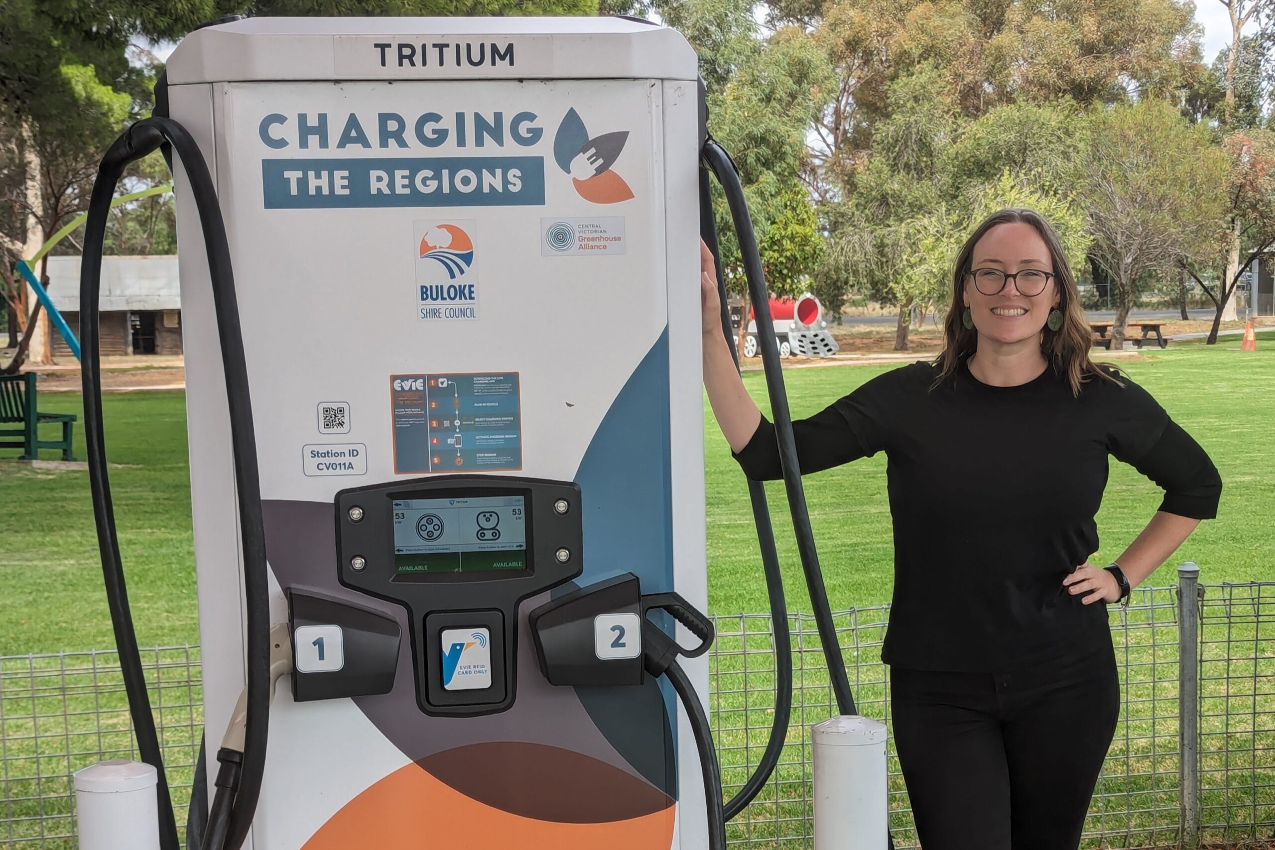 Katherine Copsey MP stands next to an Electric Vehicle DC fast charging station